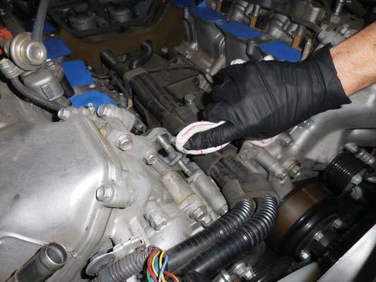 Clean the mounting surfaces of the coolant cross over with a