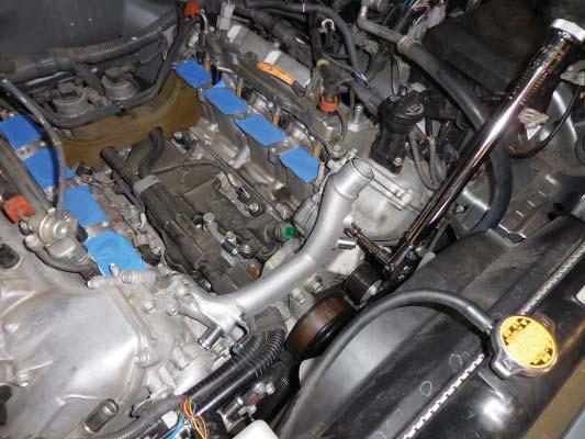 Install the supplied coolant crossover, and secure it with