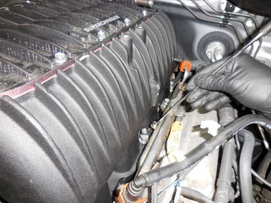 129. Install the OE bolts and nuts to secure the supercharger in place.