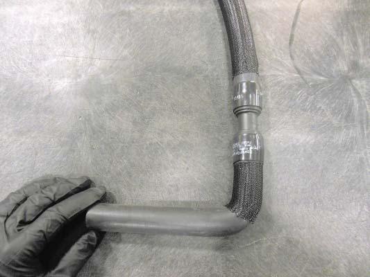 Slide the shrink clamp on the longer end of the U shaped hose, and press the opposite side of the
