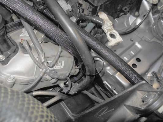 233. Use the second dual hose tie wrap to secure the two hoses at the location shown at the front of the left valve cover.