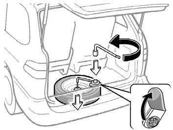 tire. This action may cause spare tire carrier damage by jamming the cable in the reel box.