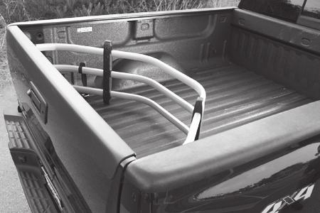 Flip BEDXTENDER out to contain cargo in the truck bed when the tailgate is open. CAUTION!