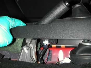 9) Lift the center console 6 to 8 inches and slide a hand