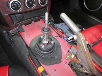 Reinstall the lower shift boot. Stretch it around the shifter adapter so that it sits low enough to seal the hole for the shifter in the body.
