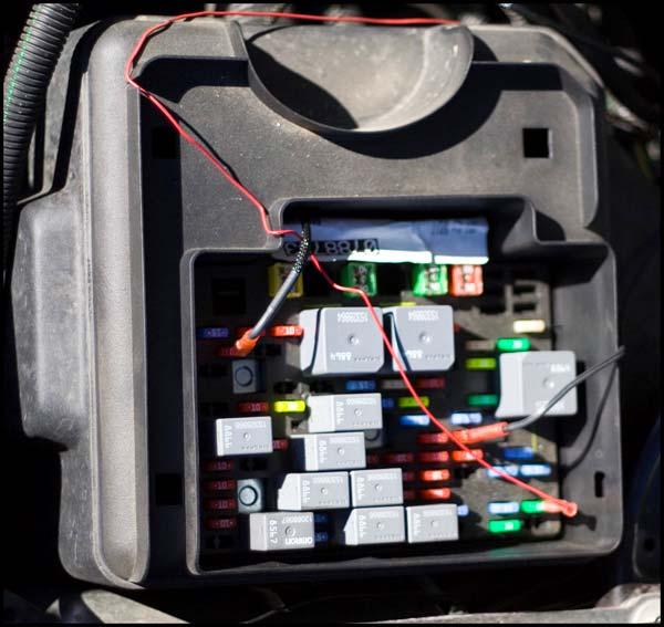 4. Run the black wire with the red end into the fuse box to connect the turbo timer.