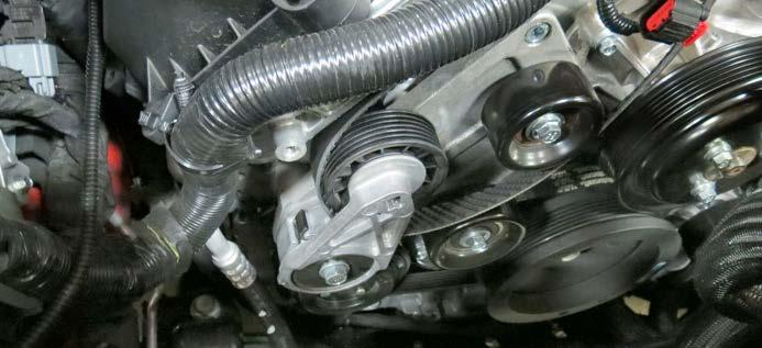 Repeat for the driver side heater hose. 64. Remove the passenger side heater hose fitting with an 8mm socket.