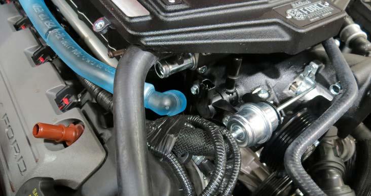 Using the two (2) factory bolts, reinstall the coolant reservoir with a