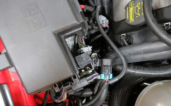Route the Intercooler Water Pump end of the Water Pump/EVAP Harness below the fuse