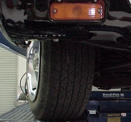 weight is on the front tires. Slide the stock bar towards the passenger side of the vehicle.
