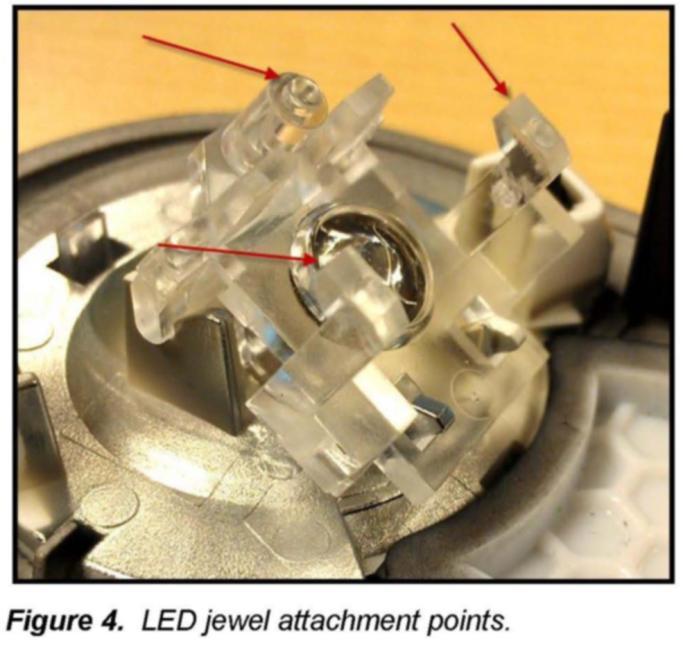 As seen in Figure 3, first pry up on the top of the small circuit-board in direction indicated by arrow 1 (away from LED Jewel).