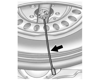 For the secondary latch to work, the spare must be installed with the valve stem pointing down. See Storing a Flat or Spare Tire and Tools under Tire Changing on page 10 67.