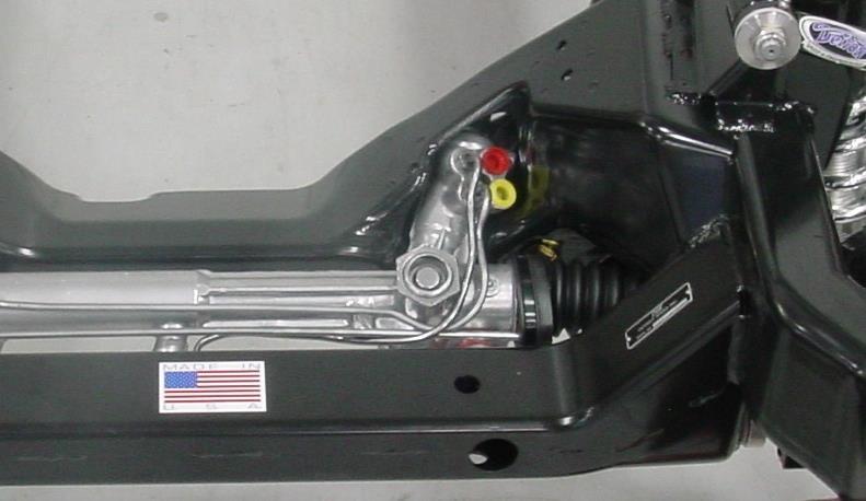 c) On the rear of the car, locate the round flanged hole in the frame rail that is next to the rear spring pockets. Drop a plumb line from this location on both sides and mark the locations.