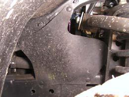 c. Remove bolt and pop-clips from passenger side rear