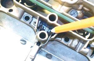 The initial adjustment for idle mixture screws on most Q-jets, for example, should be lightly seated and then Photo 6: Metering rod travel can be easily checked by inserting an applicable tool