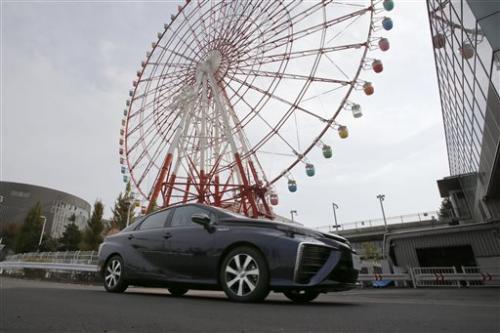 Motor Corp.'s new fuel cell vehicle Mirai drives through its showroom test course in Tokyo.