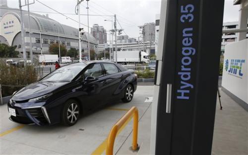 employee drives a Toyota's new fuel cell vehicle Mirai on the road near its showroom in Tokyo.