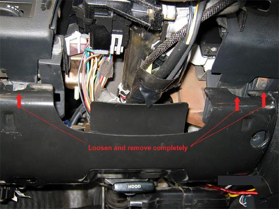 6. Now visible and can be freed by removing the two remaining 5/16 (8mm) bolts on either side of the steering column.