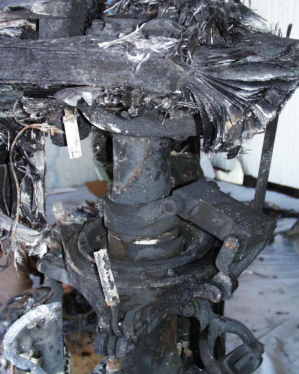 The main rotor pitch rods were broken and fire damaged and did not appear to be bent.