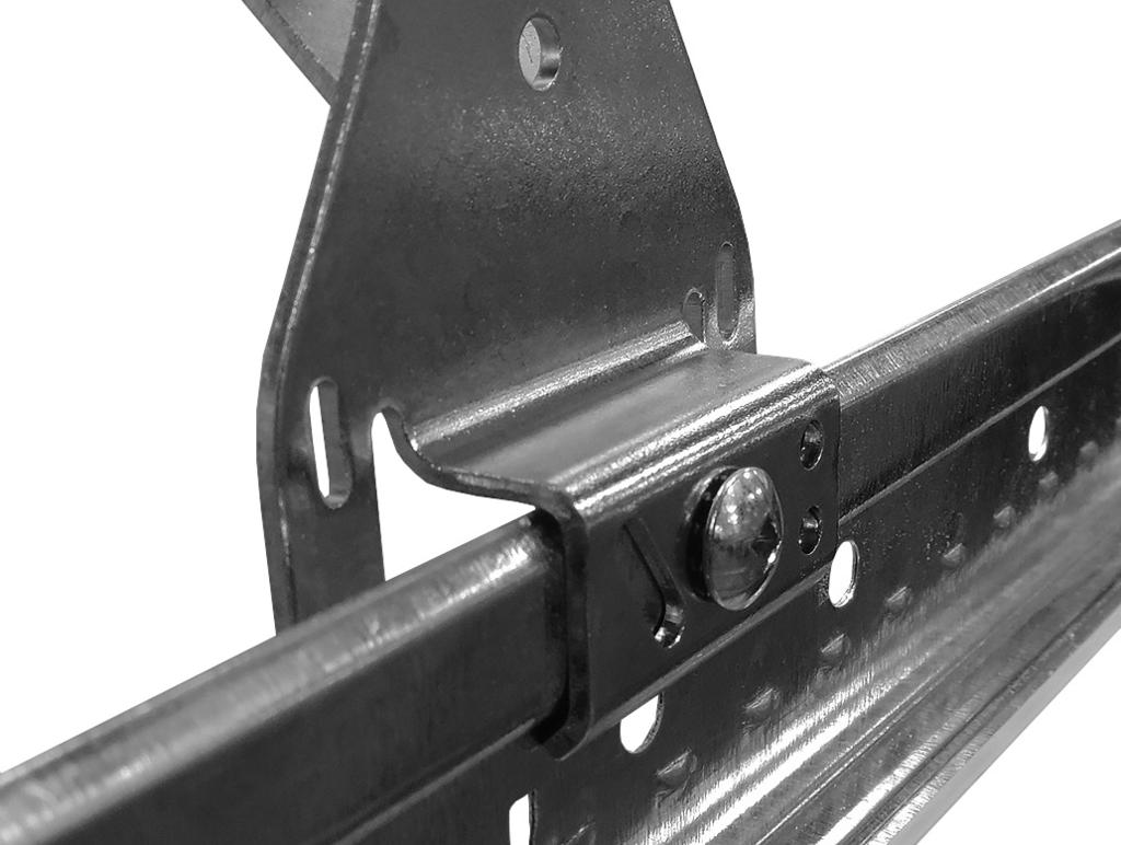 Apply light downward pressure, as shown above, to maintain the position of the end bracket flat against the T-bar rail.