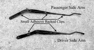 S) Peel backing from Small Adhesive Clips (part # 115066) and place on backside of wiper arms as pictured. The longer arm (passenger side) receives 3 clips while the shorter arm receives 2.