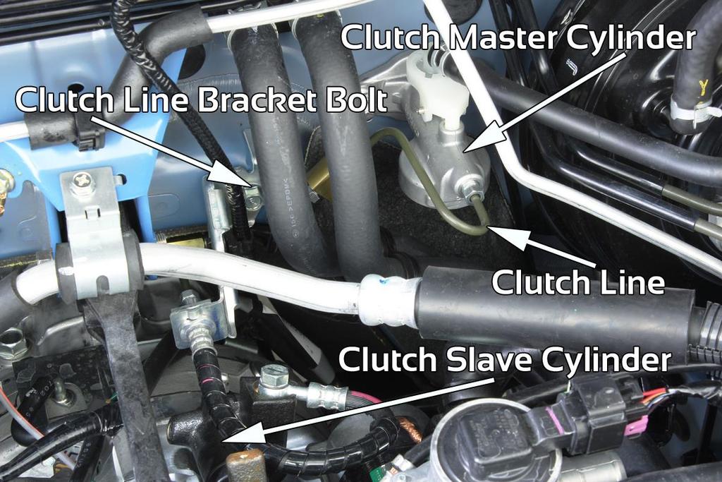 3. Remove clutch line from clutch master cylinder (10mm flare nut wrench needed for this) and from clutch slave cylinder (14mm wrench needed for this). Remove clutch line from car.