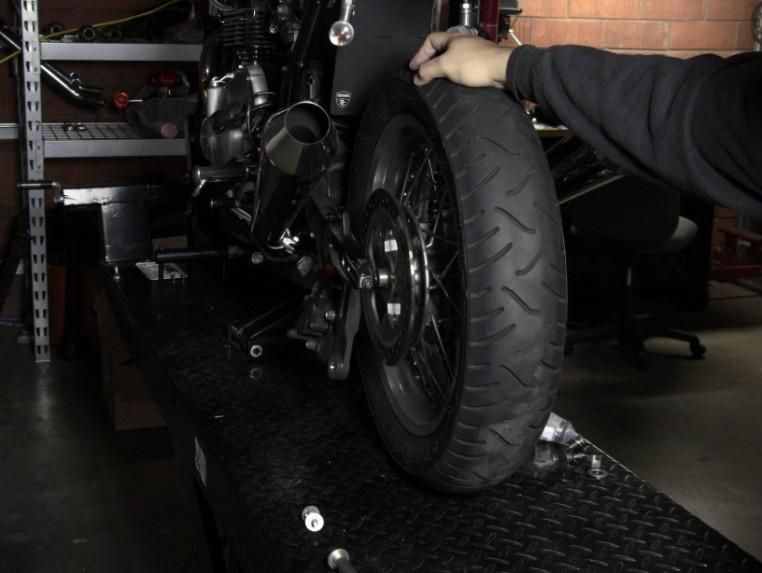 Step 17: With the battery box installed, you will need to re-install the rear wheel and shocks.