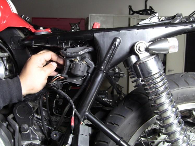 Step 20: On the RH side of the battery box, you will need to mount the rear brake reservoir and fuse block.