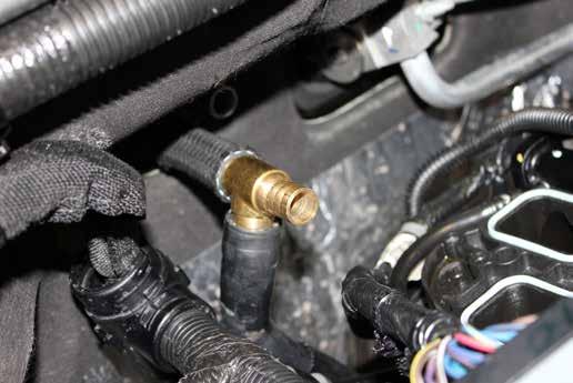 The passenger side hose uses a T-fitting and goes to the hose under the manifold and around to the