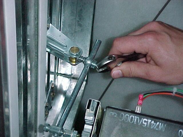 To connect the linkage to the fresh air damper, open the fresh air damper and insert the rod through the opening in the damper bracket.