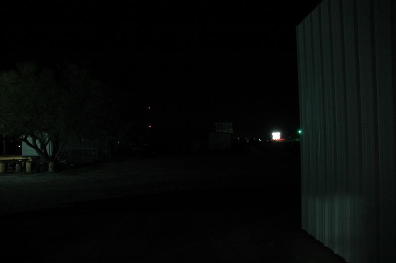 This photo shows an open parking lot lit only by ambient light at