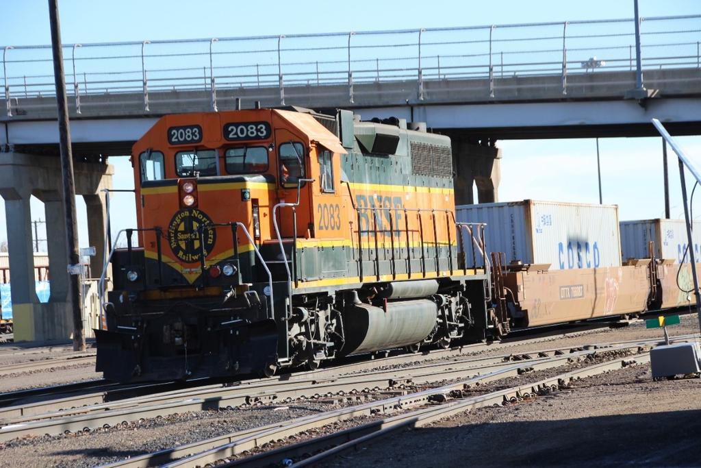 BNSF 2083, a GM GP38-2, has cut off four cars from the rear of a stack train and are moving them