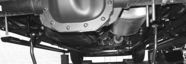 Rotate sway bar into position and attach to axle by placing the legs of the U-bolts through