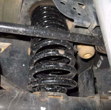 b. Repeat on opposite side of vehicle. 3. Install two kit springs (coil, rear) tiny pig tail wrap goes to bottom.
