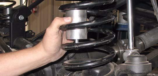 a. Position two kit spacers (bumpstop, front) into two kit springs (coil) and install two kit springs (coil) onto