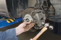 Follow the vehicle recommendations for rotor inspection and reuse. 9. Install the caliper mounting bracket.