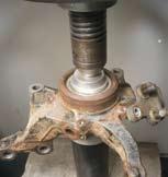 Using an appropriate press and support fixture, remove the bearing