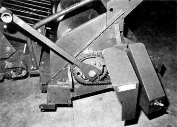 A rocking wrench and hub on the upper drive shaft were provided to facilitate unplugging (FIGURE ). FIGURE 6. Stone Retarder Stop Block. FIGURE. Feeder Conveyor Rocking Hub and Wrench. FIGURE 7.