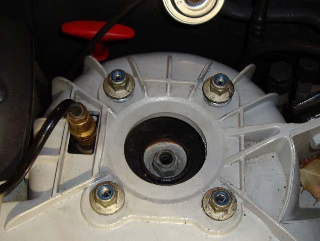 7. DISCONNECT THE AIR LINE FROM THE CHECK VALVE AND THE FOUR (4) SHOCK MOUNTING NUTS. (FIGURE 10-5) 8. REMOVE AIR STRUT.