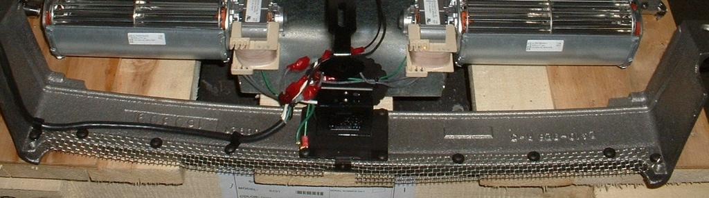 Use a phillips head screwdriver to remove the 2 screws securing the wire loops holding the power cord.