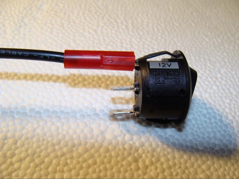 e. Connect the flat spade terminal of the BLACK 20g POSITIVE wire to Terminal 1 (12V label) of the switch. (Figure 9).