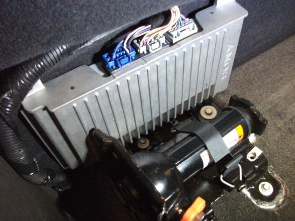 Mount the factory amplifier as shown in Figure 11 using one of the factory subwoofer bolts.