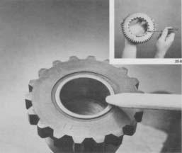 Use a drive gear bearing nut remover to turn nut from shaft,