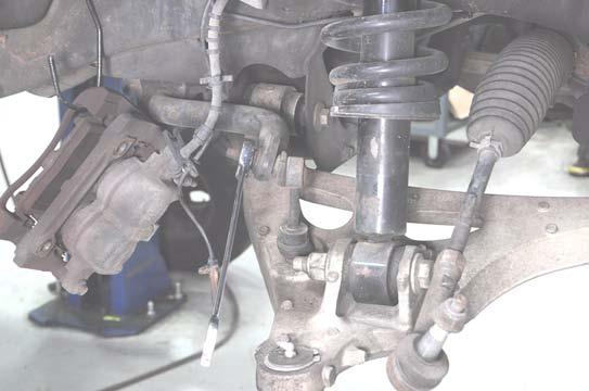 Using a 22mm wrench, loosen the lower ball joint nut.