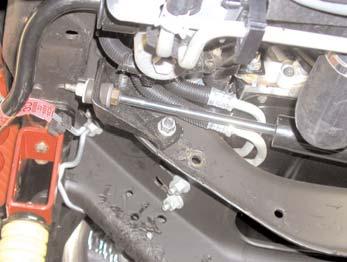 23. Remove the factory steering stabilizer. Remove the factory bracket from the crossmember using 18mm socket. (See Photo # 22) 24.