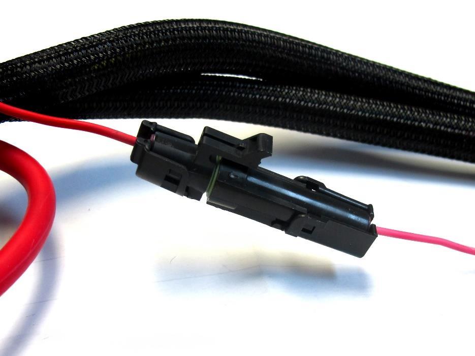 Step 32: First, connect the pigtail to the male connector on the Track Rocker Fuse/Relay Center. Then, route the wire to your ignition source.