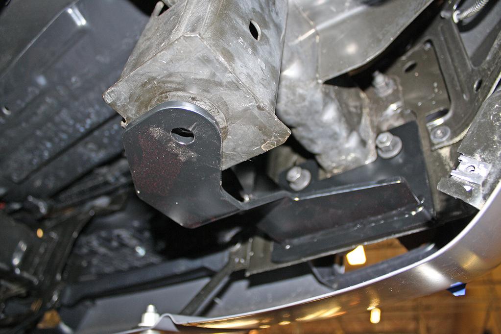 On each side, use a hammer to flatten the tab on the bumper mounting flange, or a cut-off wheel to remove it (Fig.E).