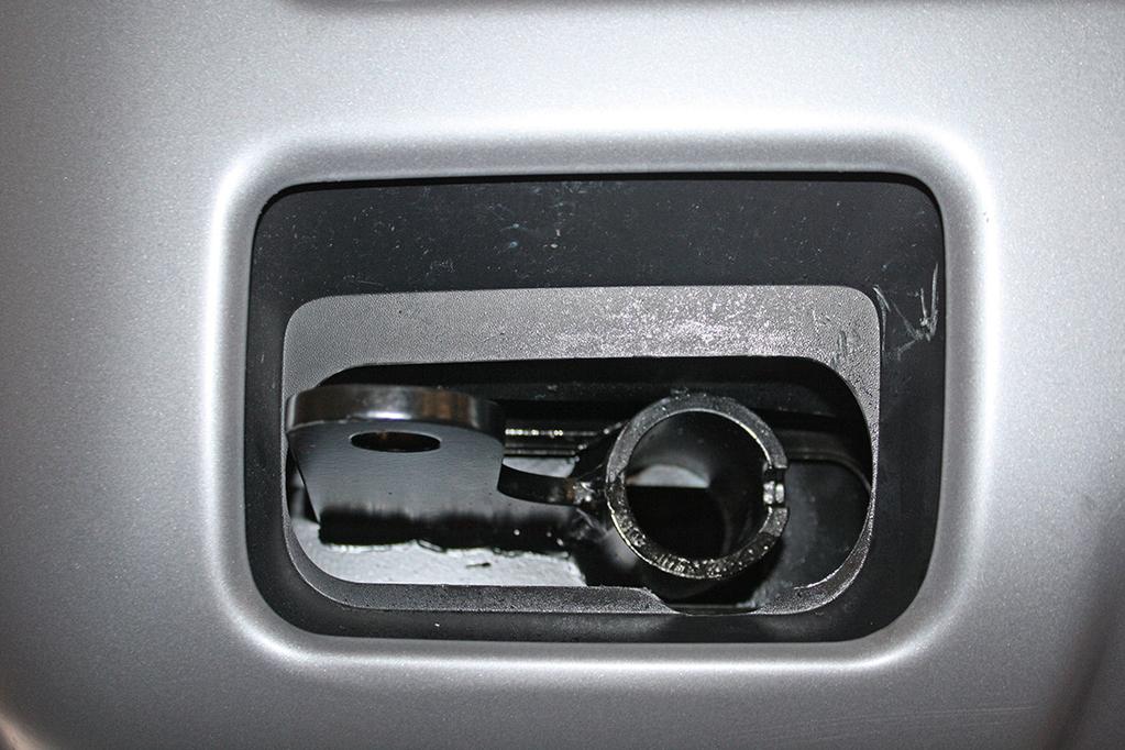 On each side, use a die grinder to enlarge the existing holes in the frame (Fig.H).