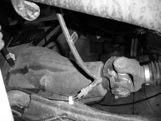 7. Remove the front axle hub vacuum lines retaining clips from the
