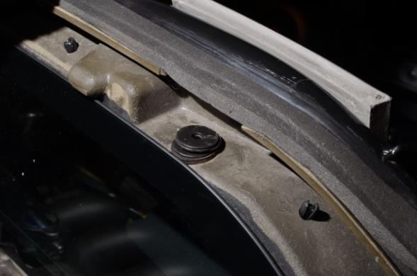 Remove windscreen washer fluid bottle by simply pulling up. It will slide off the bracket. 23. Locate the edge trim on the side ducts. Peel the upper (clam) section down and off of the body.